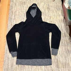 Soft Black Lululemon Runaway fleece with hood, pockets, and thumb holes.